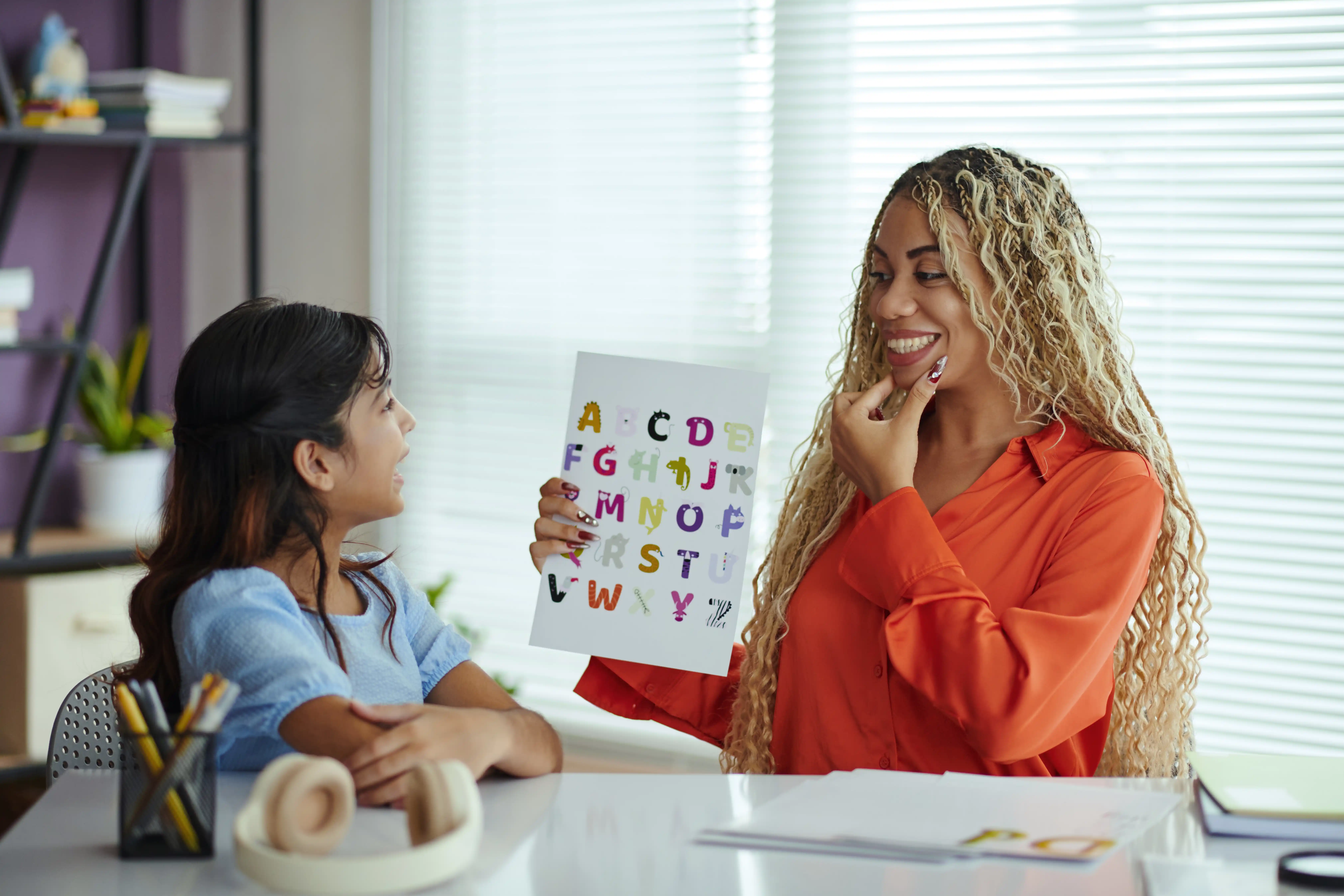 Life ABA clinician conducting a BCBA assessment with a young girl using educational flashcards.